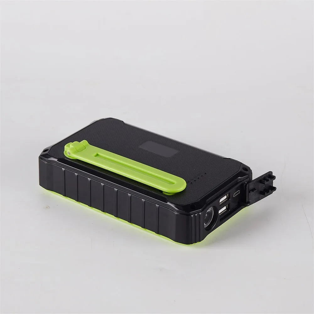 Green and orange portable solar hand crank power bank showing USB ports, solar panel, and hand crank
