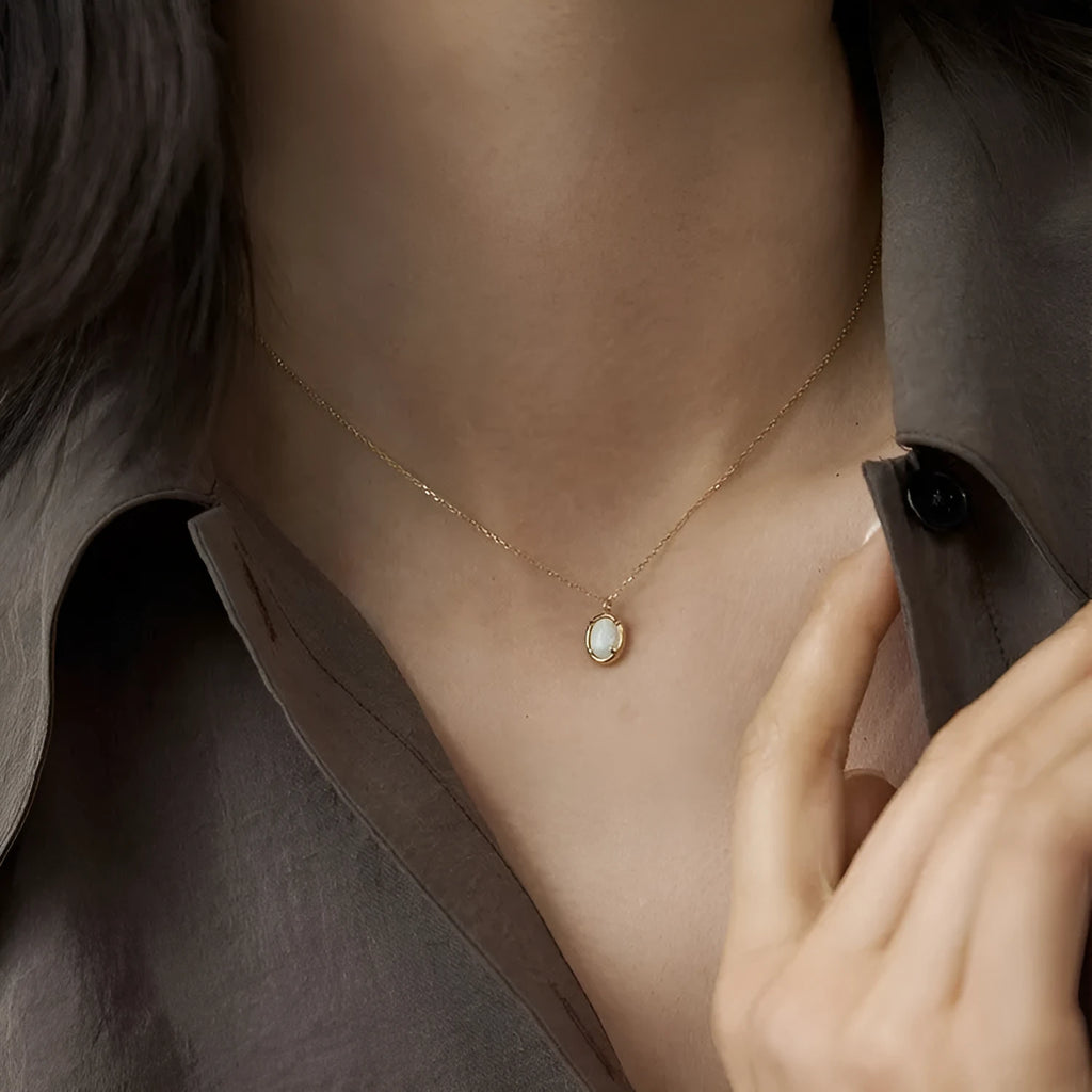 Oval S925 silver pendant necklace with a round jelly opal, shown in both gold tone and white gold tone finishes.