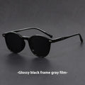 Retro round frame sunglasses with polarised grey lenses on a neutral background.