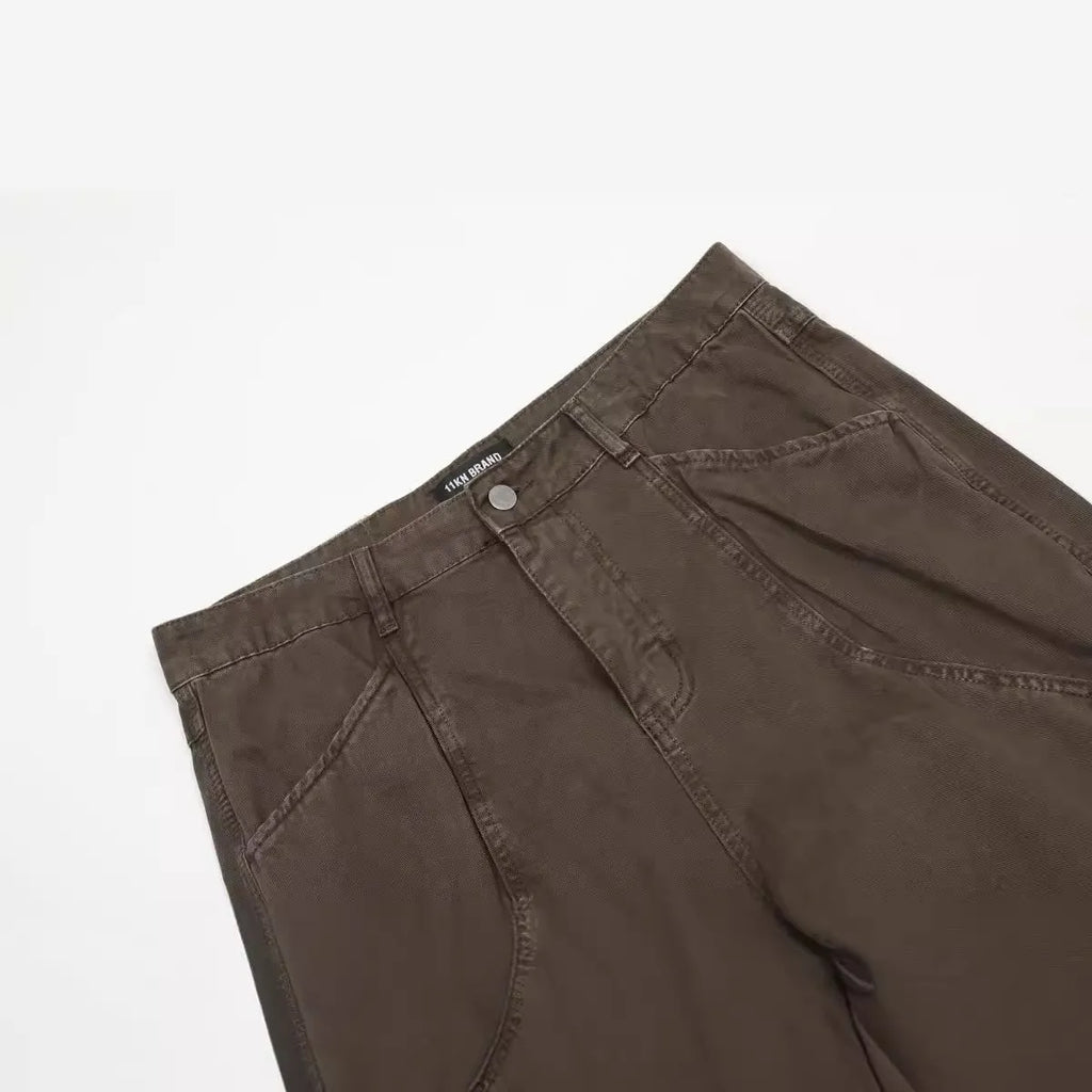 Men's brown straight-leg jeans with high waist and zip fly on mannequin