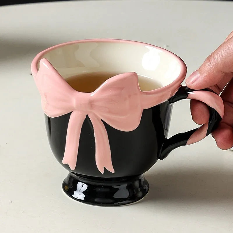 Ceramic mug with heart bow design in black pink or white powder colour, 301-400ml capacity