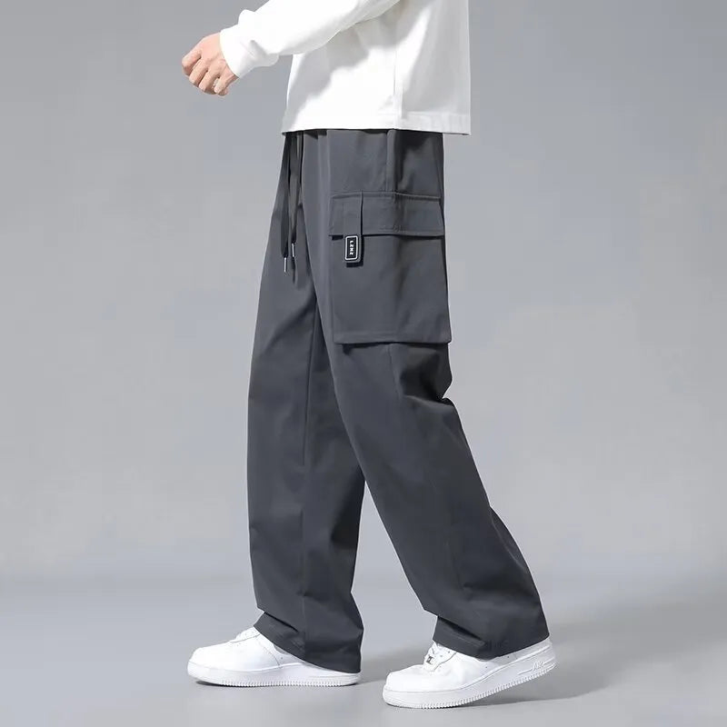 Boys' straight-leg cargo trousers in Army Green with drawstring waist and large side pockets.