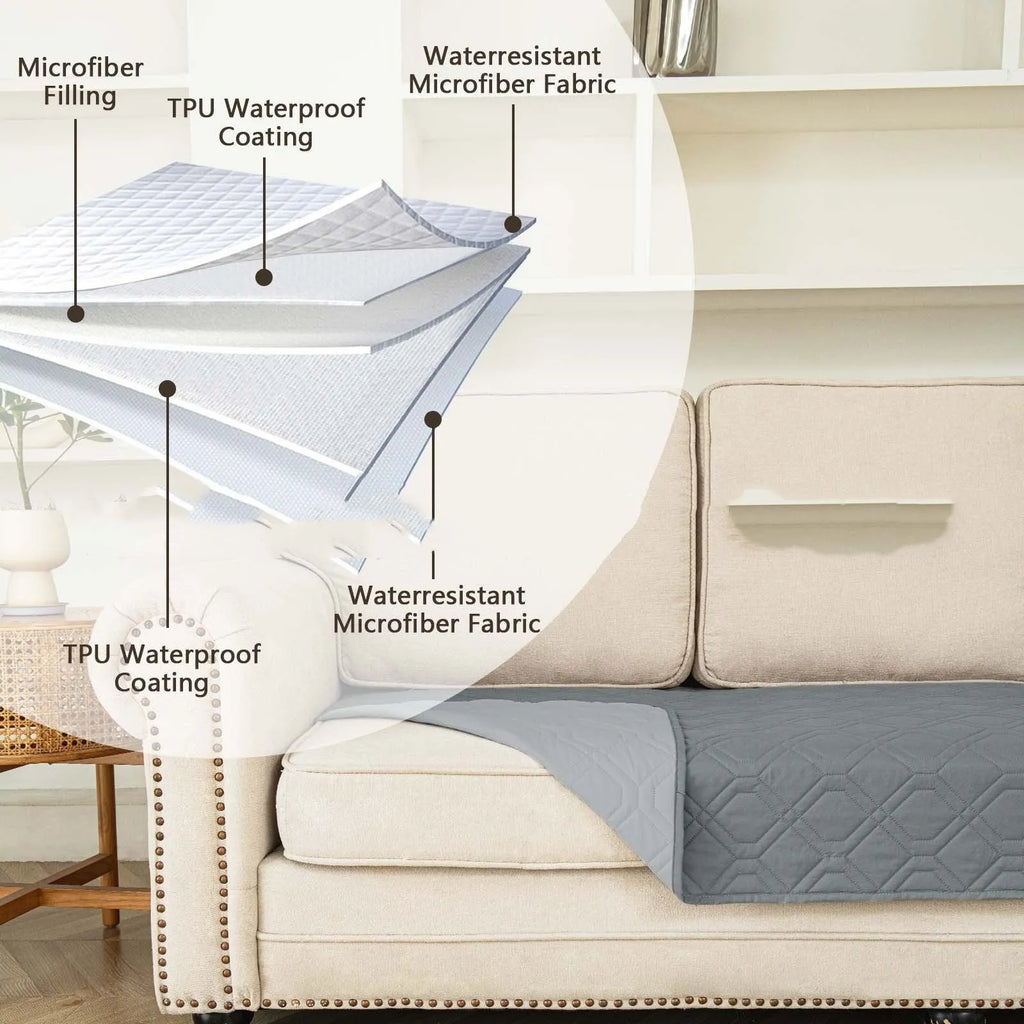 Dark grey and light grey double-sided waterproof dog cushion on a sofa