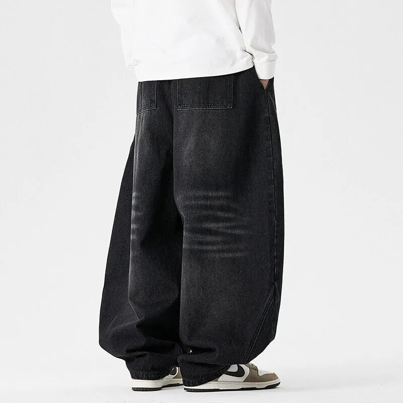 Men's loose fit plus size jeans in dark blue denim showing wide leg and low waist style.