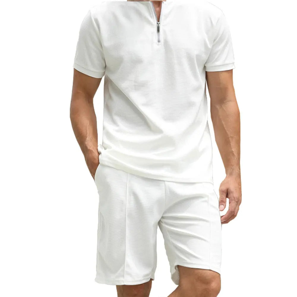 Men's solid colour polo shirt and matching trousers two-piece set on a hanger.