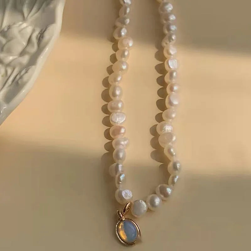 Vintage-style adjustable pearl choker necklace with a geometric alloy pendant on a silver-toned chain.