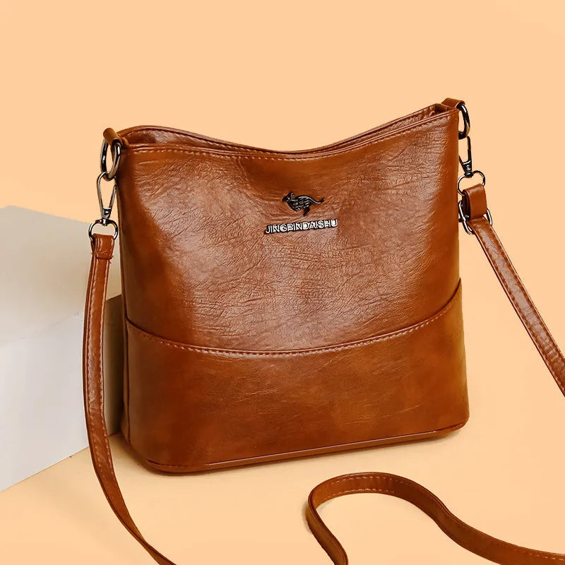 Women's soft leather bucket-style shoulder bag in black colour showing minimalist design and shoulder strap
