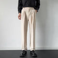 Men's straight loose fit suit trousers in apricot colour on a hanger.