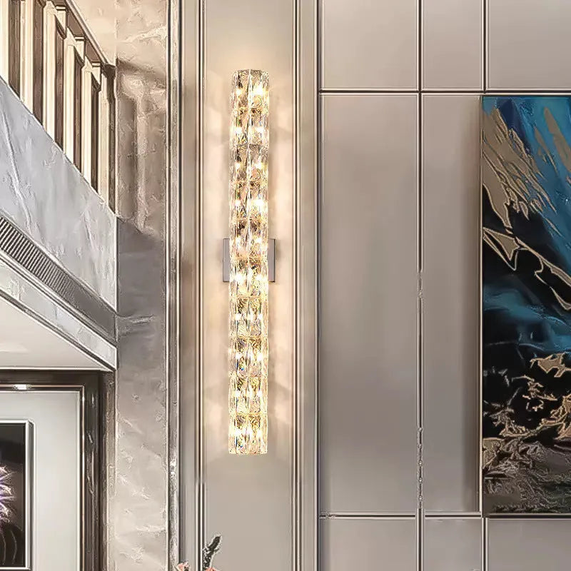 Slim crystal wall lamp with stainless steel body in chrome or gold finish, mounted on a wall.