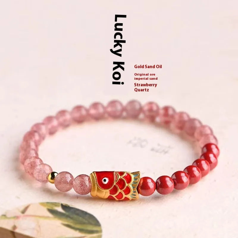 Women's bracelet with purple cinnabar and pink strawberry quartz beads, koi design, on wrist.