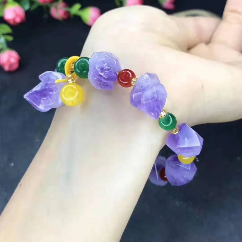 A natural style women's bracelet made with amethyst-shaped beads and a decorative fu character.