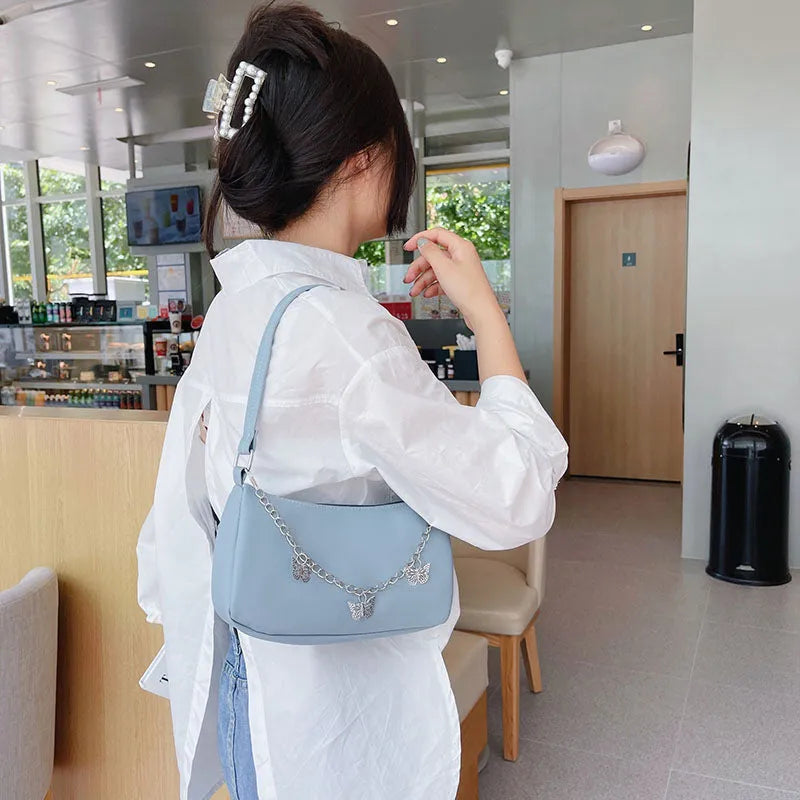 Horizontal square PU crossbody bag with chain strap in retro style showing internal phone and document pockets.