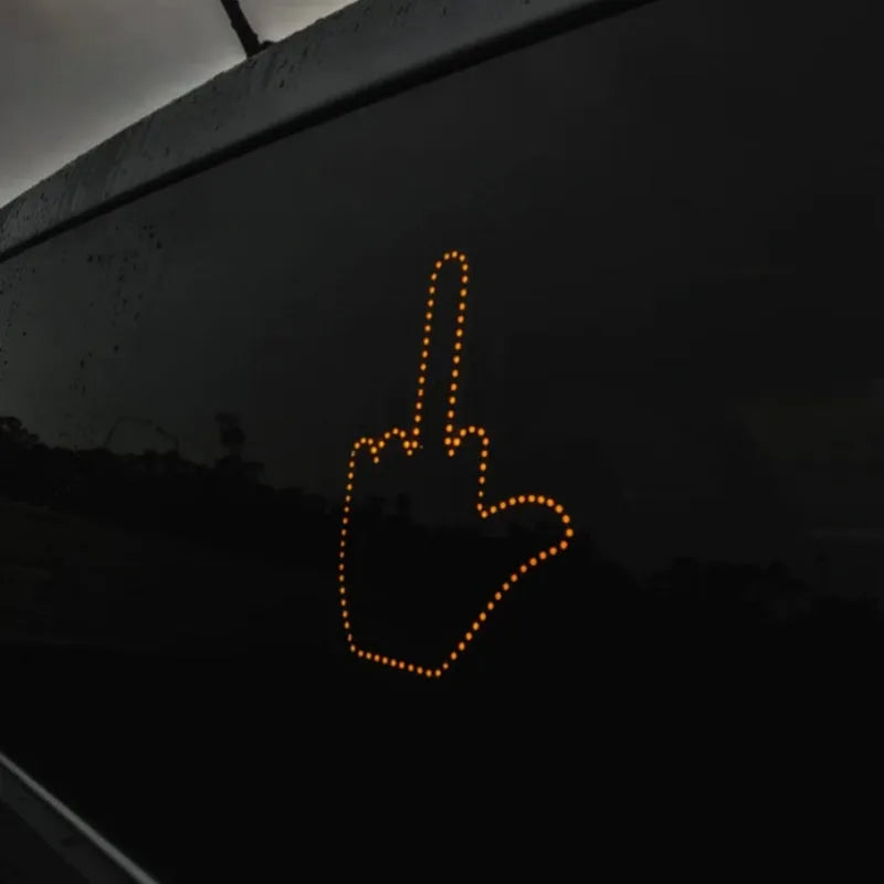 Black plastic LED gesture car light with remote control showing illuminated hand symbol.