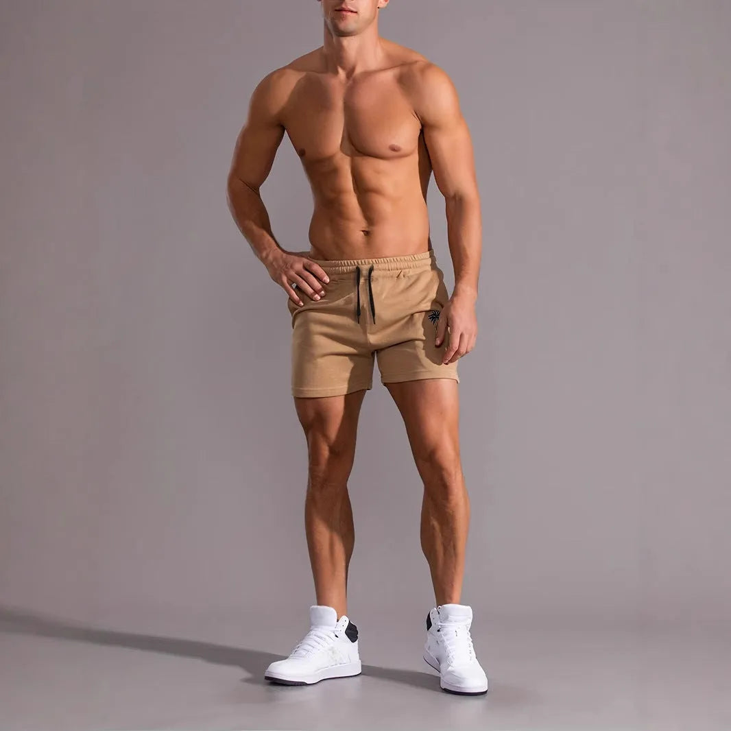 Man wearing khaki coconut print straight-leg sports shorts made of polyester