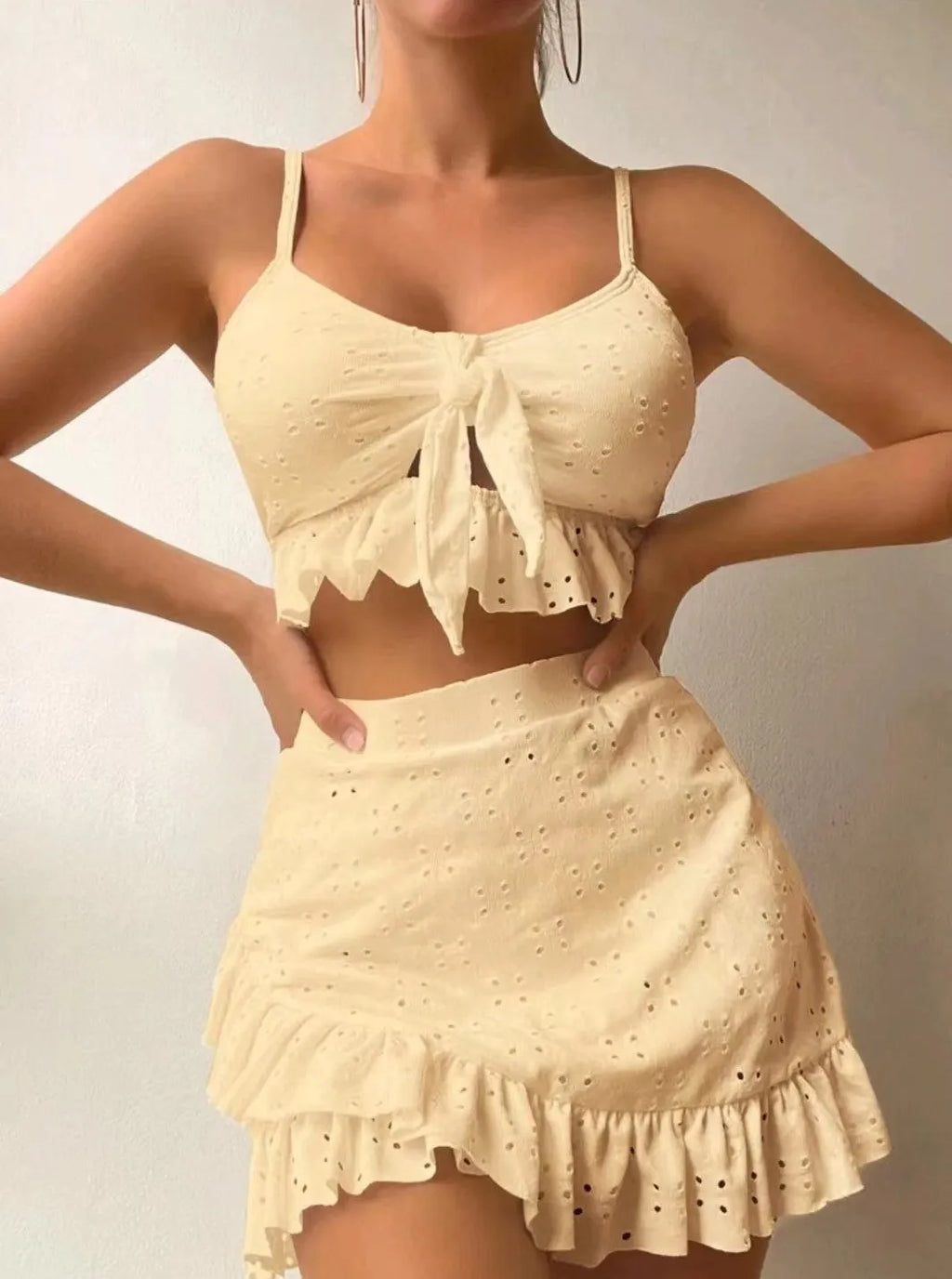 Women's white split-hip skirt swimsuit three-piece bikini on a mannequin.