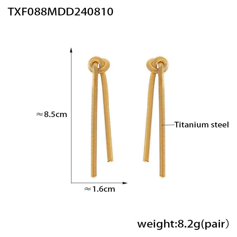 Gold colour titanium steel necklace with knotted tassel pendant and matching earrings on a white background.