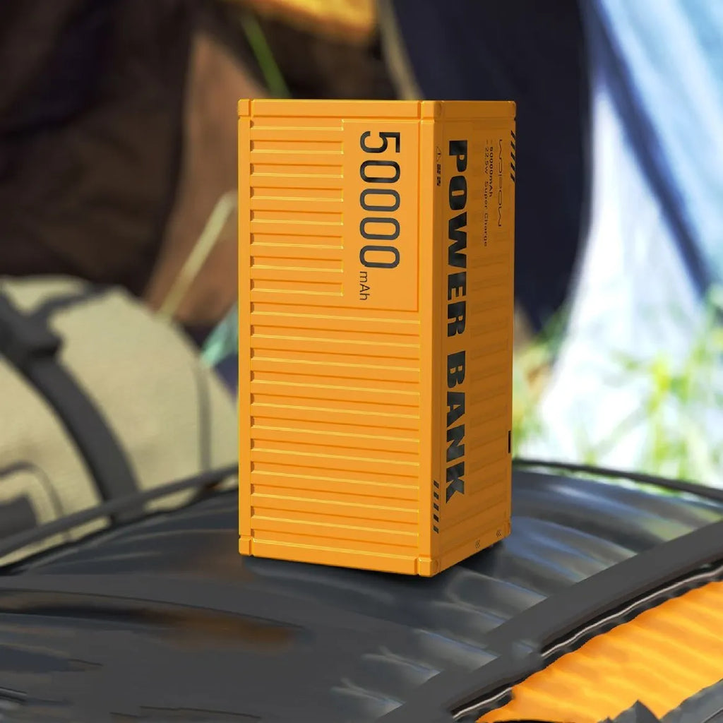 Large 50,000mAh power bank with digital screen and five USB output ports in yellow, black, or silver.