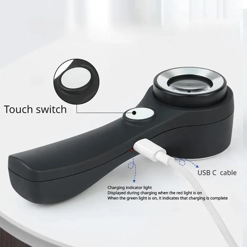 Black handheld magnifying glass with optical glass lens for jewellery and collectible appraisal