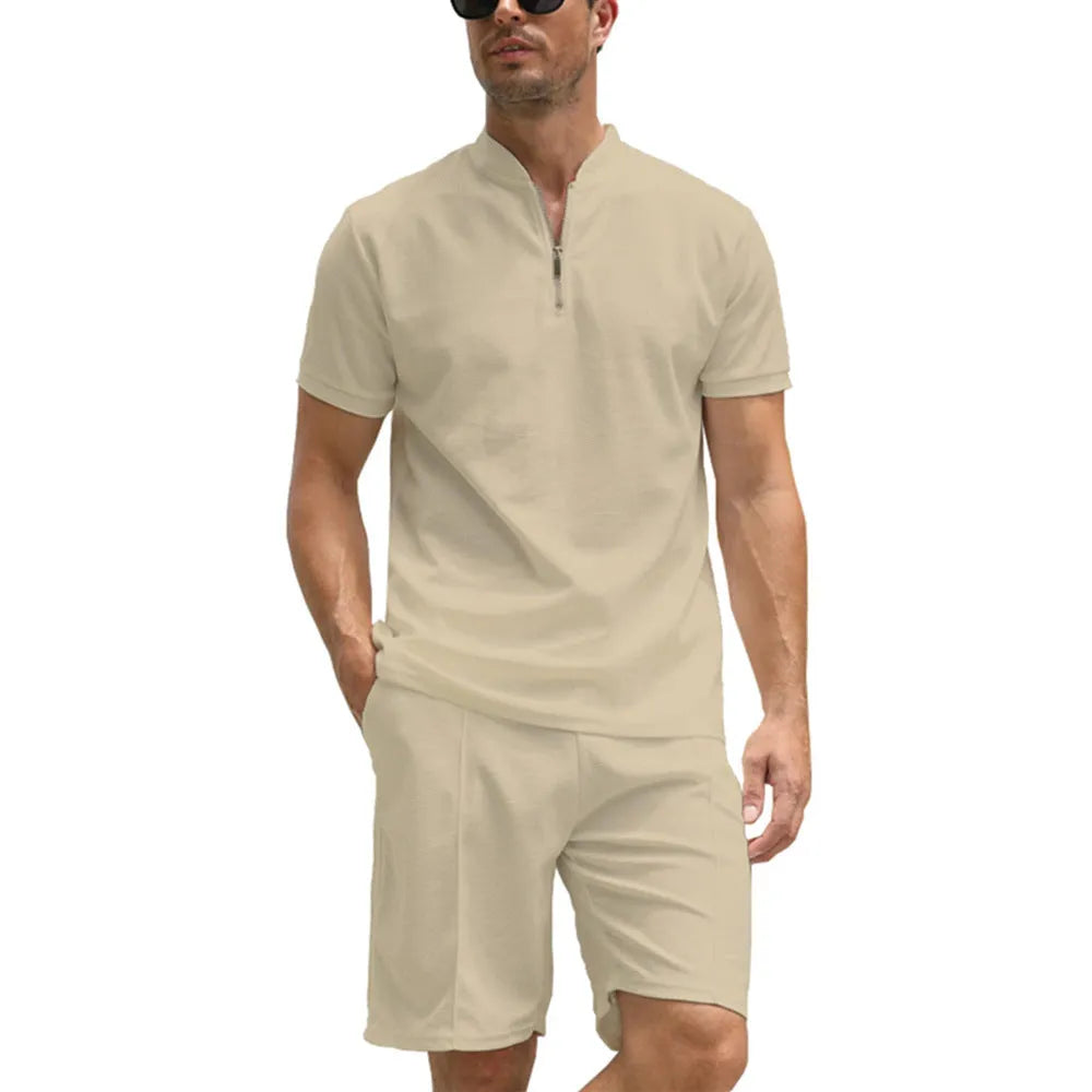 Men's solid colour polo shirt and matching trousers two-piece set on a hanger.