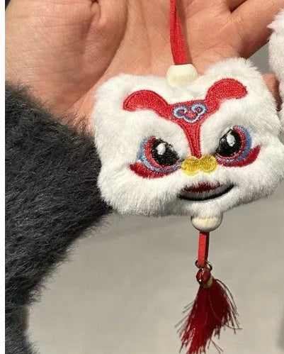 Handmade blue and yellow Chinese style plush lion keychain ornament with tassel and star stone.