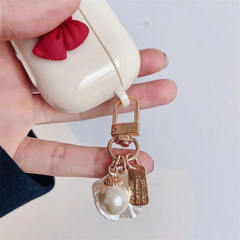 Beige red bow shell TPU AirPods case with clamshell opening design