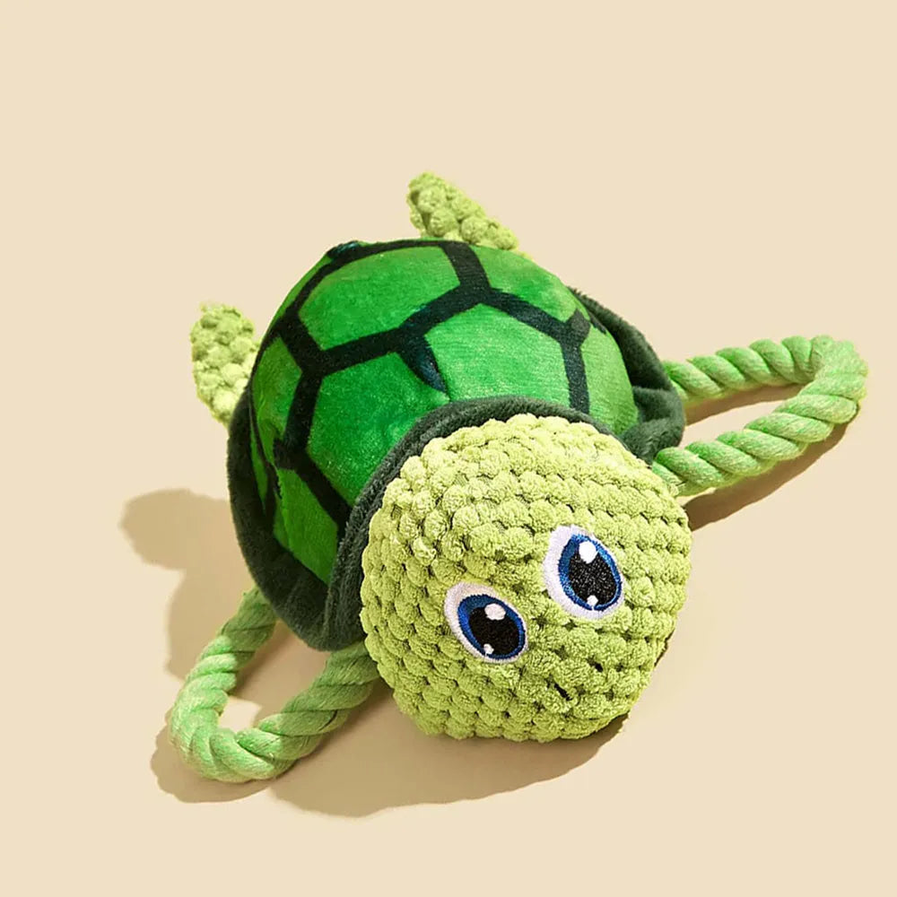 Grey, green, and orange turtle-shaped plush dog toy showing its knotted rope centre.