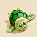 Grey, green, and orange turtle-shaped plush dog toy showing its knotted rope centre.
