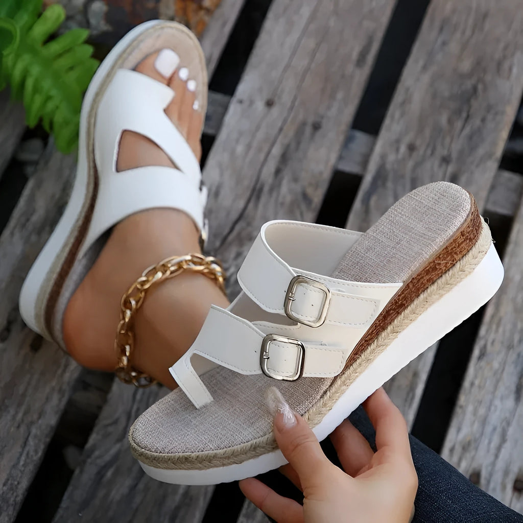 White patent leather wedge sandals with woven peep toe and finger fit design