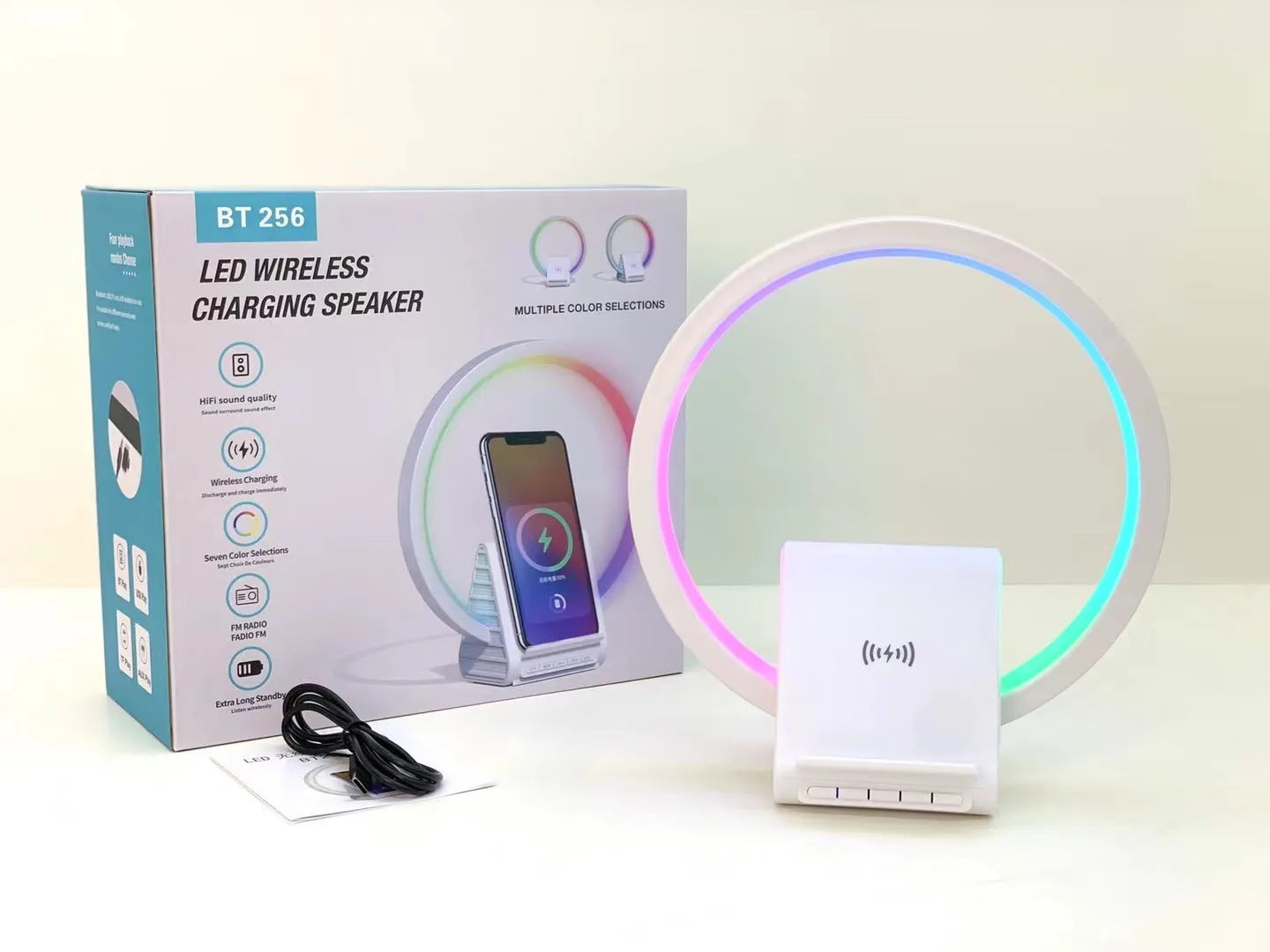 White rectangular smart Bluetooth speaker with wireless charging pad and ambient lighting