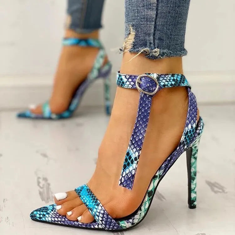 Blue women's high heel shoe with buckle fastening and pointed toe on a white background.