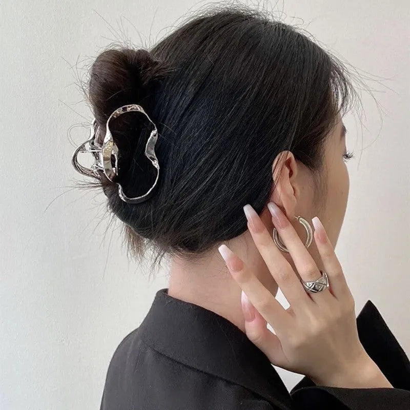 Silver electroplated metal hair claw barrette in a Korean-style design on white background