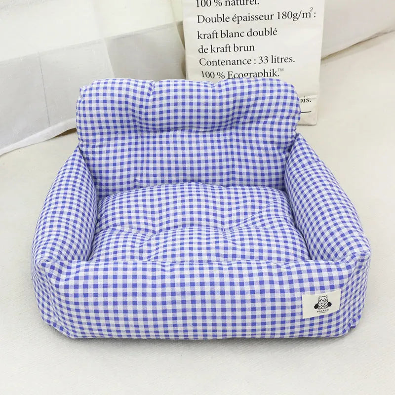 Grey and blue plaid car-mounted stain-resistant dog travel nest in two sizes.