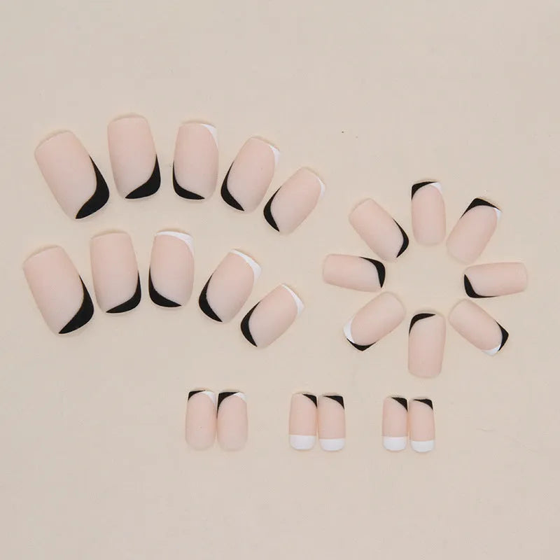 Black and white frosted matte false nails with French style design on display