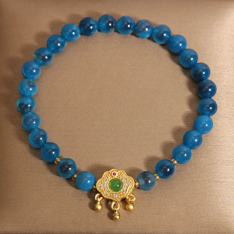 Blue sugar heart agate safety lock pendant on a crystal women's bracelet with alloy inlay and rhinestones.