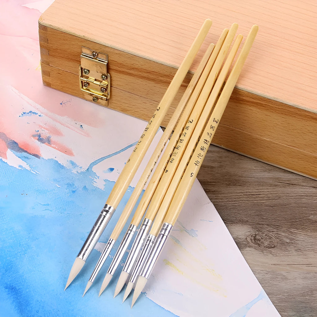 Six wooden brush pens with pointed wool felt tips arranged together as an artist set
