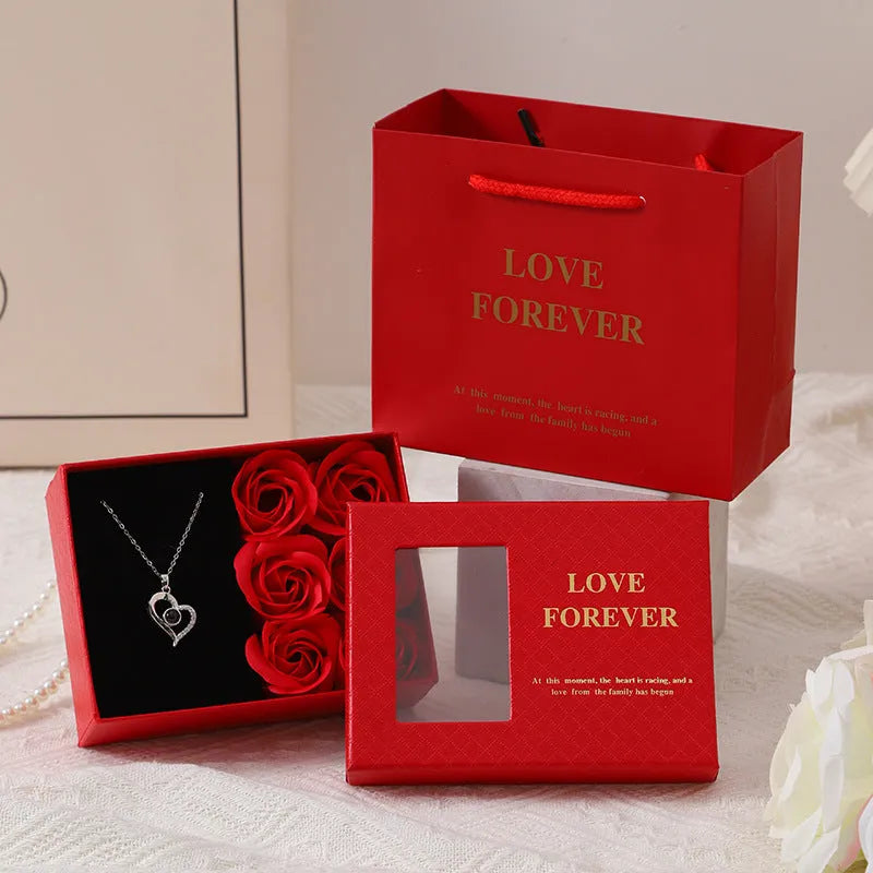Six scented soap flowers in red pink or black inside a gift box with matching handbag