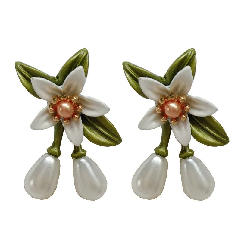 Women's alloy flower earrings showing sterling silver needle detailing on studs and contrast colours on clips