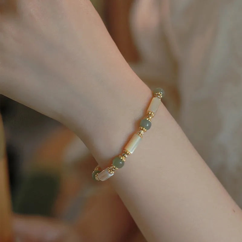 Natural white lip shell Hetian jade bracelet with round beads and geometric design