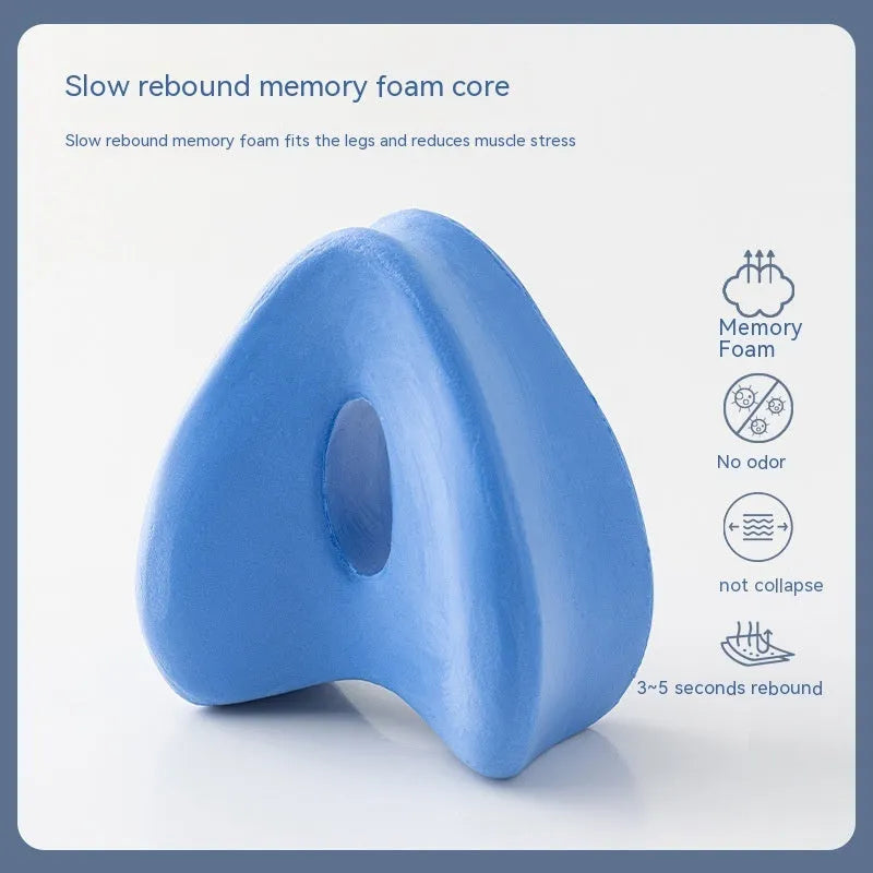 Love heart-shaped dark blue jacquard memory foam leg pillow on a bed.