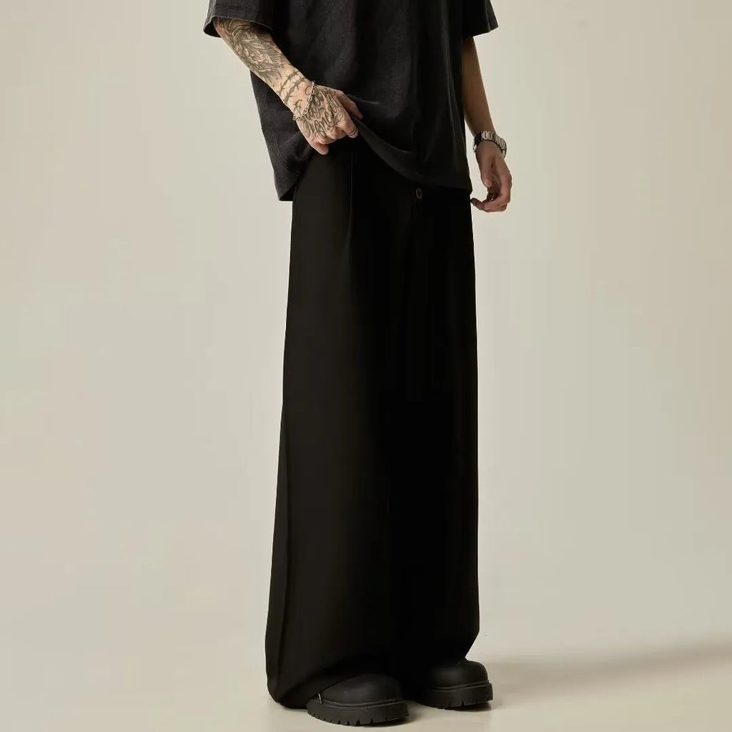 Men's black casual trousers with wide-leg design and button front in polyester cotton blend fabric