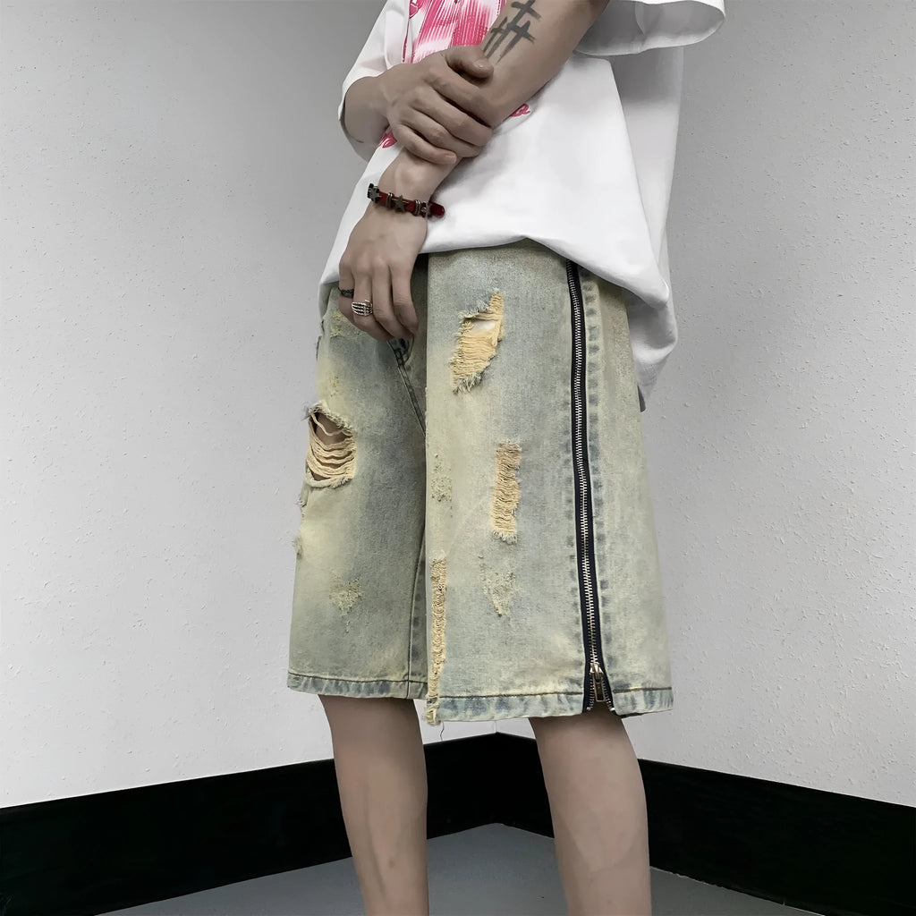 Retro blue men's denim shorts with yellow mud wash and ripped details, loose fit.