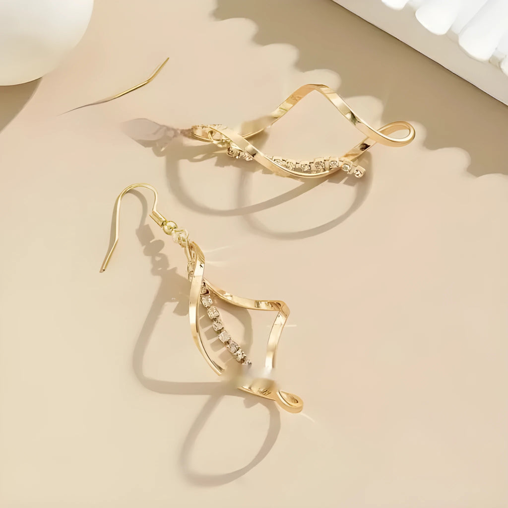 Gold colour female earrings with creative spiral design and geometric ellipse shape