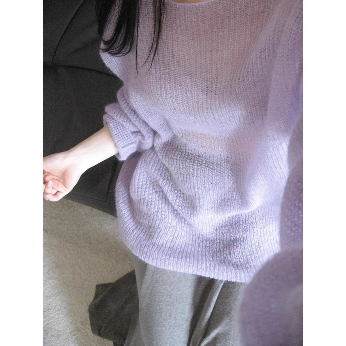 Purple women's blouse with hollow out pattern, princess sleeves, and shoulder strap detail on hanger