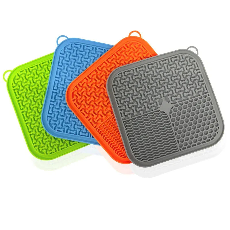 Orange red and grey silicone dog licking mat with textured surface and suction cups on back
