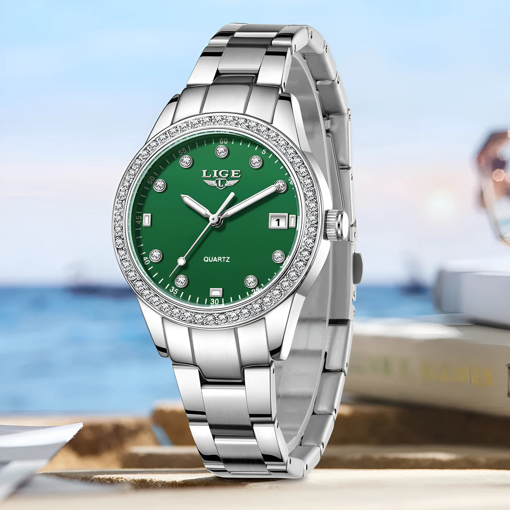 Silver stainless steel women's quartz watch with diamond bezel and luminous hands on a round 34mm dial.