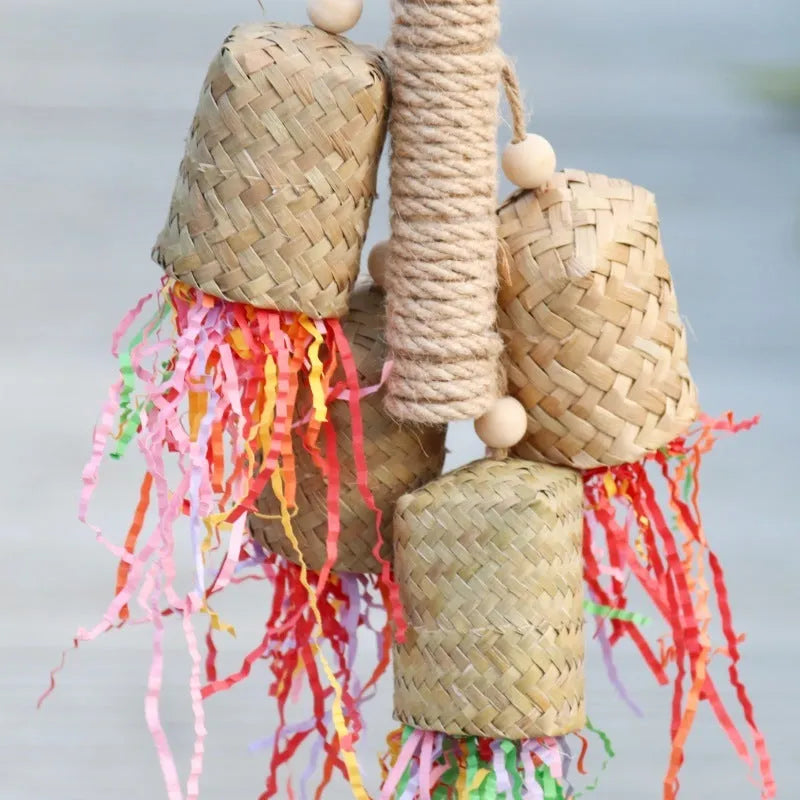 Parrot toy with wood pieces, sisal rope and colourful shredded paper strips hanging for bird enrichment