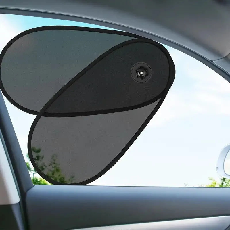 Black stretchy car side window sunshade for babies attached with suction cups, shown in a compact stored size