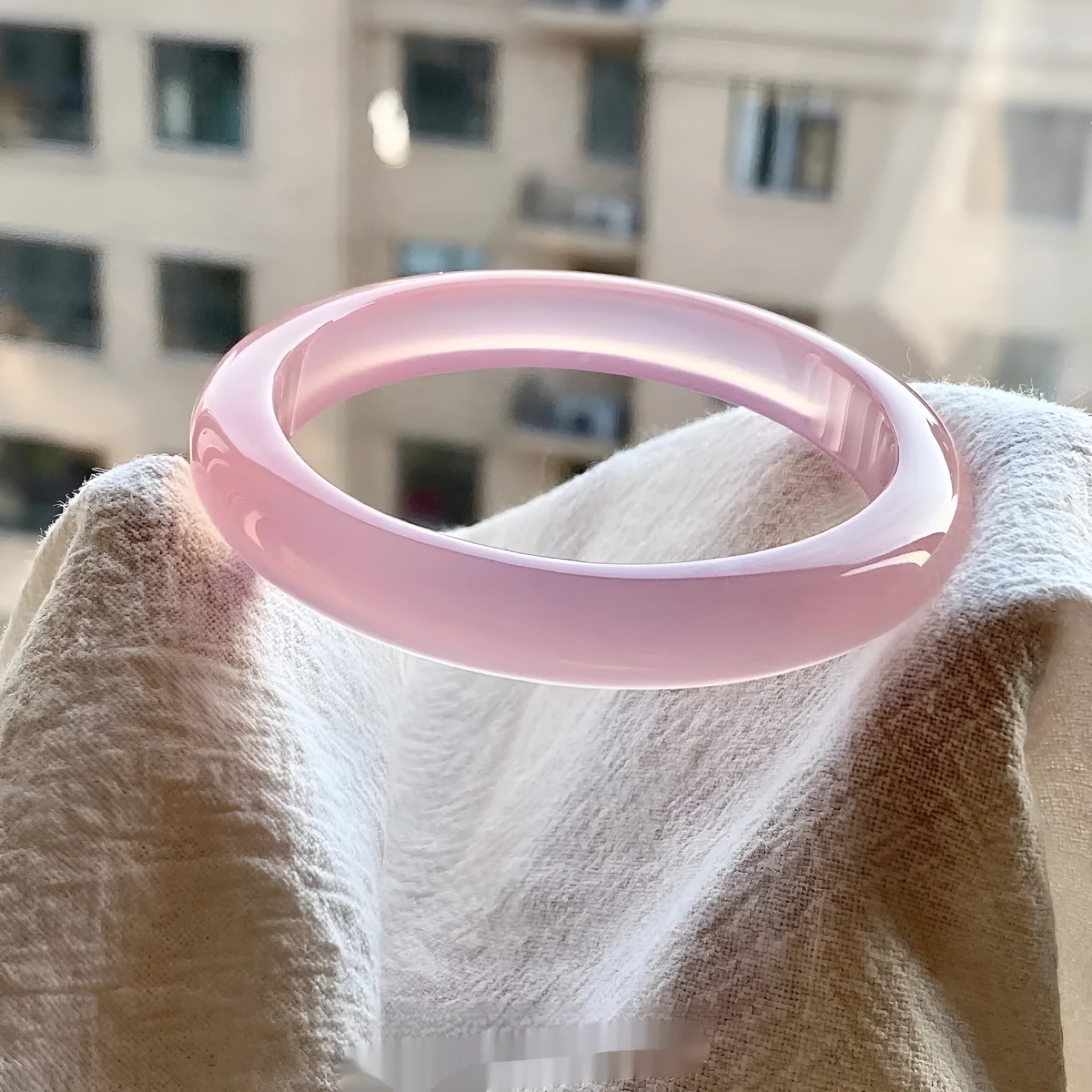 Natural agate wide tyre bead bracelet in pink, showing banded stone patterns on a wrist.