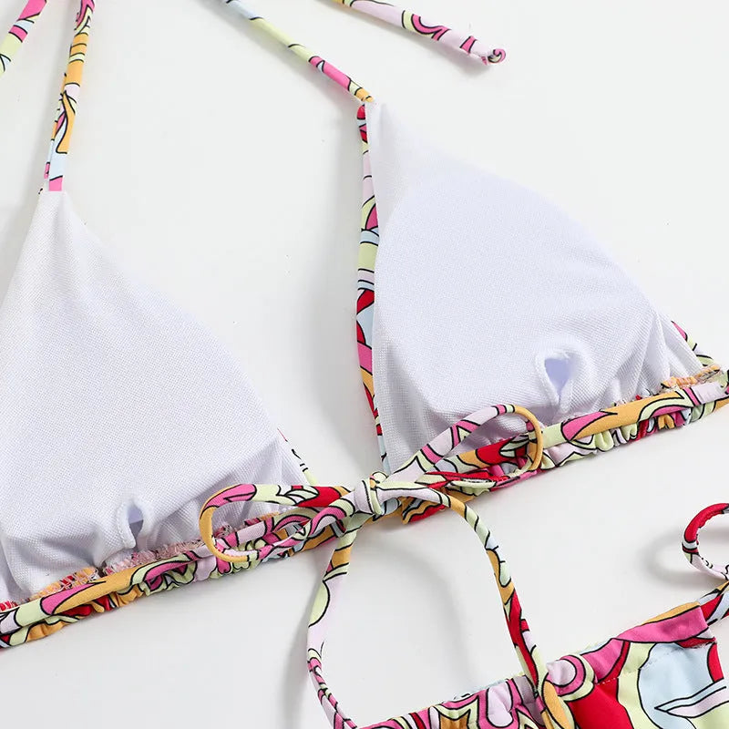 Multicolor printed women's triangle bikini top with hanging neck and matching bottoms.