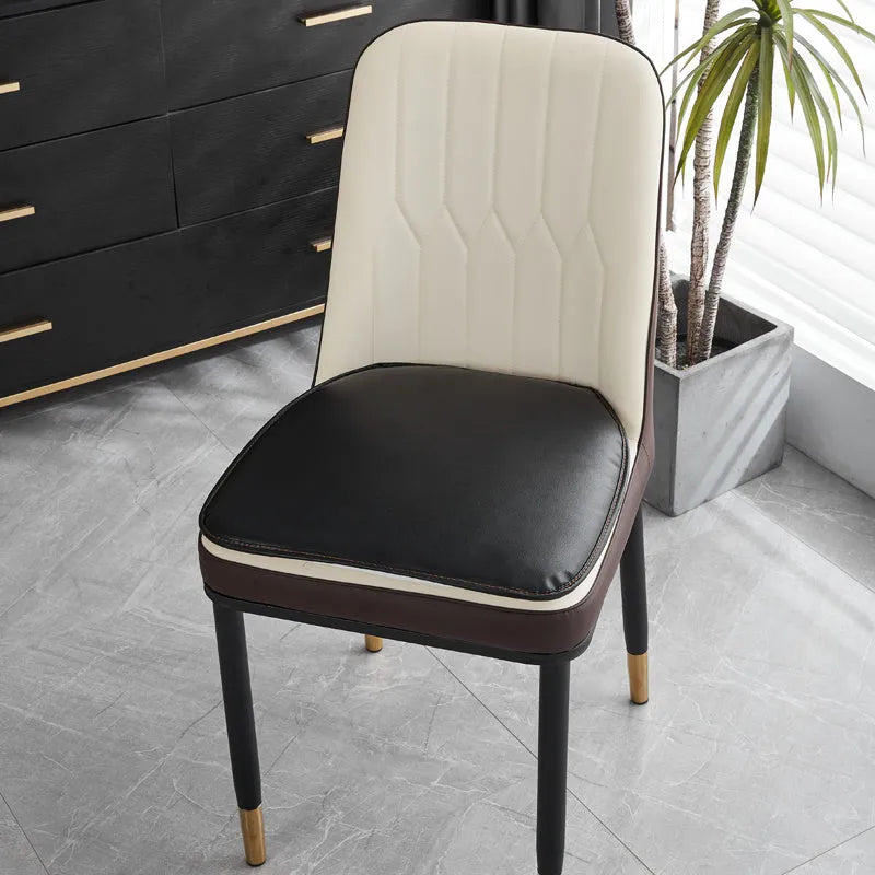 Leather horseshoe-shaped non-slip seat cushion in a solid colour on a wooden chair